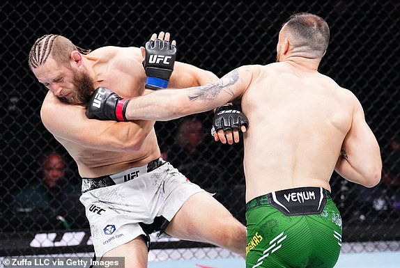 MANCHESTER, ENGLAND - JULY 27: (R-L) Modestas Bukauskas of Lithuania punches Marcin Prachnio of Poland in a light heavyweight bout at UFC 304 event in Manchester, England.  (Photo by Chris Unger/Zuffa LLC via Getty Images)