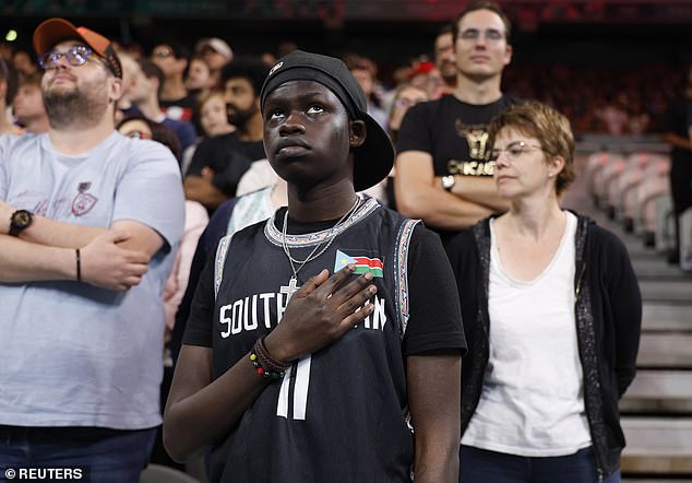 A fan appears confused as another national anthem plays