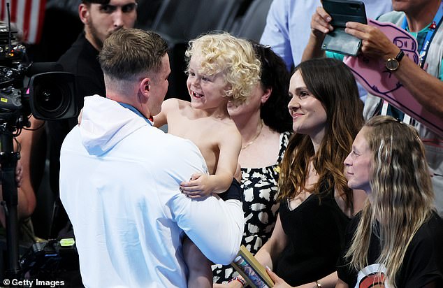 Adam Peaty embracing his three-year-old son after winning Olympic silver on Sunday