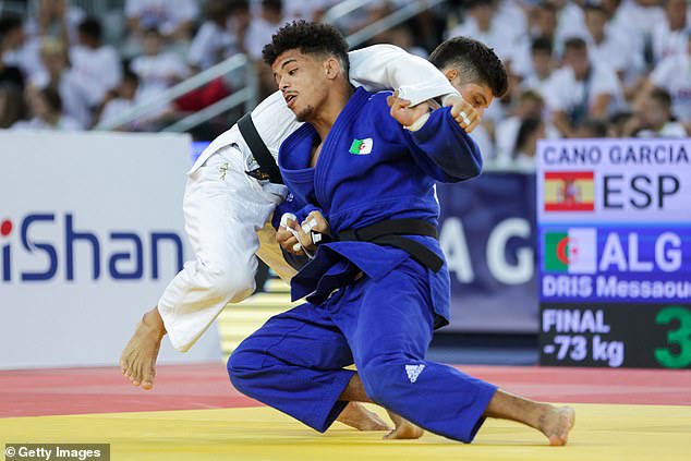 Israel has accused disqualified Algerian fighter Redouane Messaoud Dris (above, in blue) of deliberately failing a weigh-in to avoid fighting their judoka Tohar Butbul at the Paris Olympics