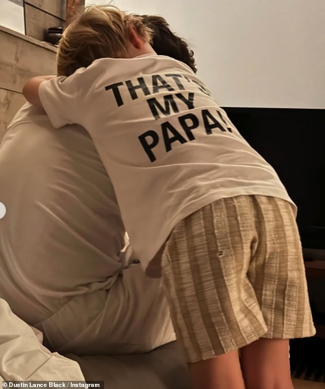Daley beamed while showing off his medal and cuddled up to his youngest son, before eldest Robbie could be seen proudly draped in a Union Jack flag