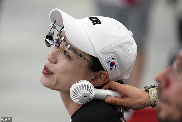 Kim using a handheld fan to stay cool