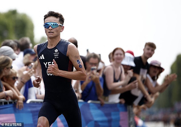 Alex Yee storms to the finish line to win the men's triathlon
