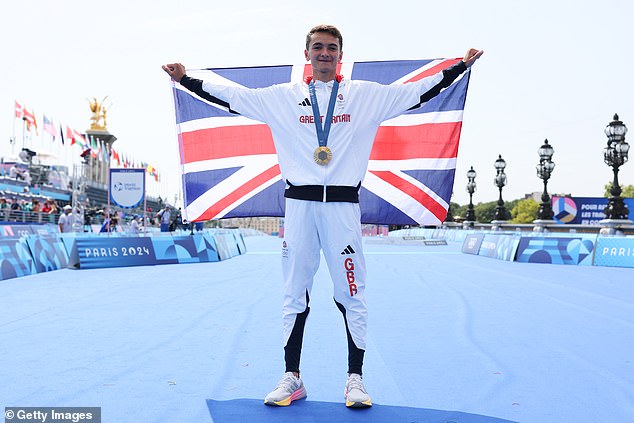 Gold medalist Alex Yee of Team Great Britain poses for a photo during the triathlon medal ceremony