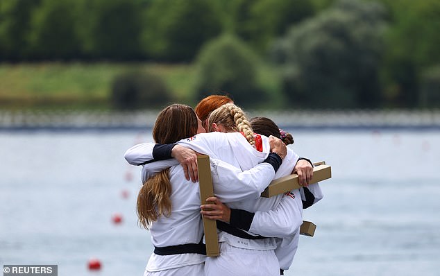 Gold medallists Lauren Henry of Britain, Hannah Scott of Britain, Lola Anderson and Georgina Brayshaw of Britain hug, as they celebrate on the podium after winning