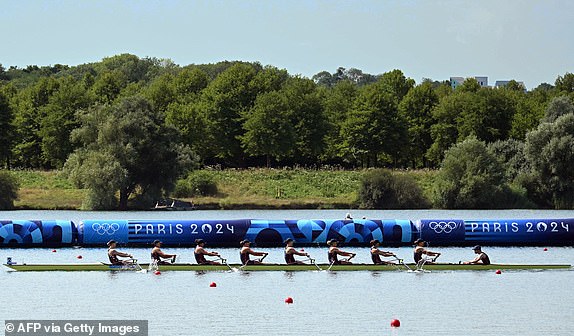 (From L) Britain's Heidi Long, Rowan Mckellar, Holly Dunford, Emily Ford, Lauren Irwin, Eve Stewart, Harriet Taylor, Annie Campbell-Orde and coxwain Henry Fieldman compete in the women's eight heats rowing competition at Vaires-sur-Marne Nautical Centre during the Paris 2024 Olympic Games on July 29, 2024. (Photo by Bertrand GUAY / AFP via Getty Images)