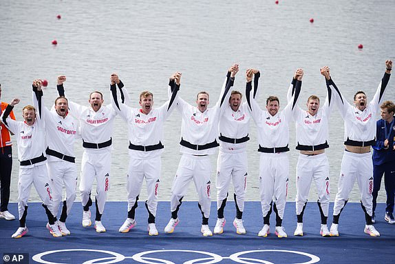 Britain's Tom Digby, Harry Brightmore, Charles Elwes, Rory Gibbs, James Rudkin, Tom Ford, Jacob Dawson, Morgan Bolding and Sholto Carnegie celebrate after winning gold in the men's eight rowing final at the 2024 Summer Olympics, Saturday, Aug. 3, 2024, in Vaires-sur-Marne, France. (AP Photo/Ebrahim Noroozi)