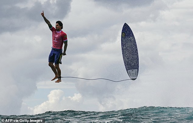 Gabriel Medina raised his hand to the sky as he 'kicked out' to end his record-beating run