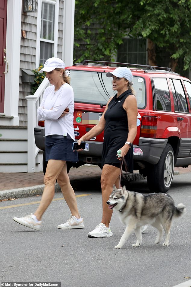 Holliday was spotted outside the home on Monday while running to the recycling plant with her dog Nike – the Husky she shared with Belichick