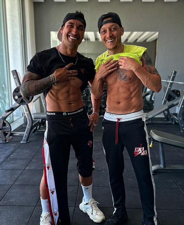 Ozil (right) previously attracted controversy over a tattoo which appeared to reference far-right extremist group the Grey Wolves