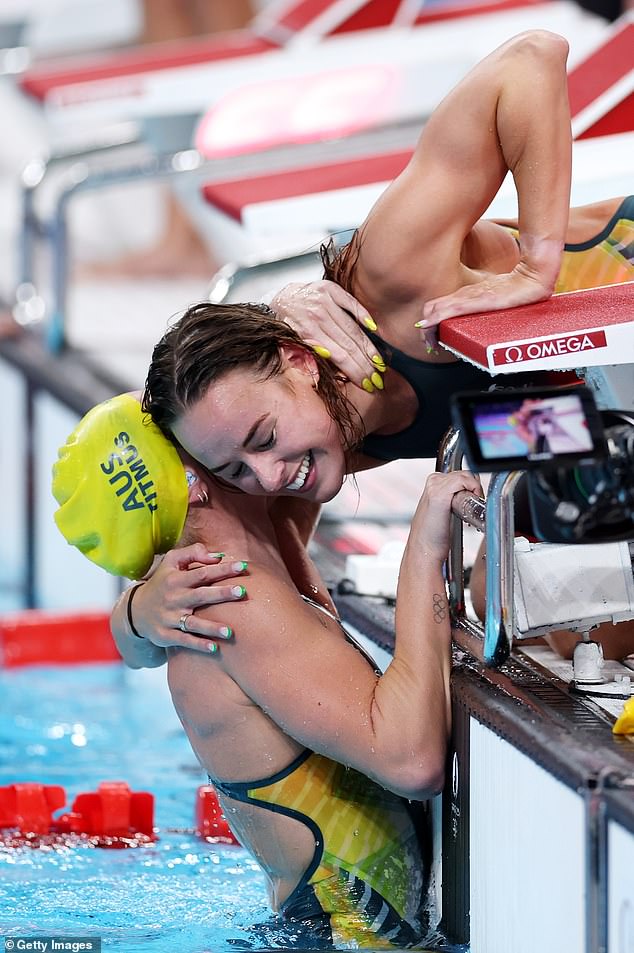 Titmus is embraced by Brianna Throssell following the team's victory in Paris