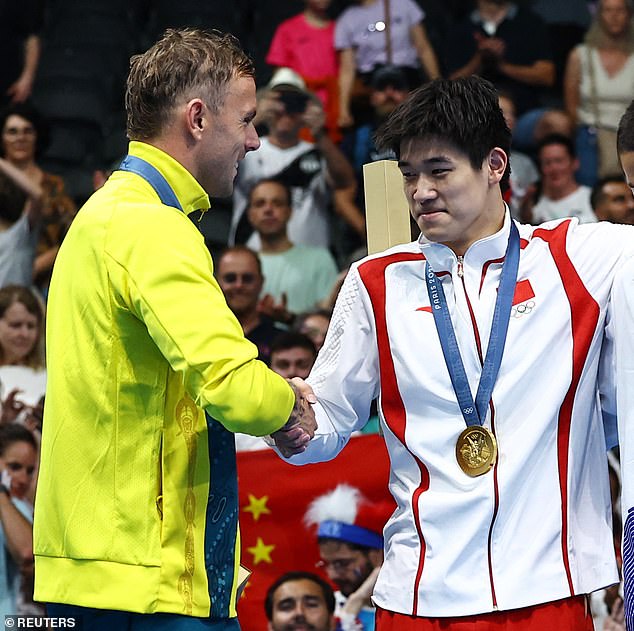 Chalmers was snapped warmly shaking Pan's hand after they received their medals