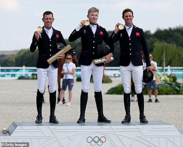 Gold medalists Scott Brash, Harry Charles, and Ben Maher celebrate during the Jumping Team Final medal ceremony in 2024.