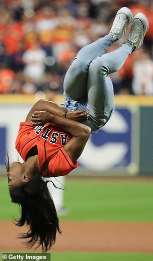 Team USA's gymnastics star performed a backflip before successfully throwing her opening pitch