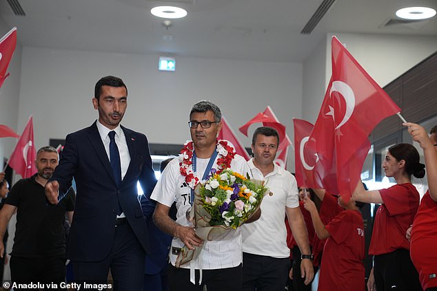 Dikec's cool demeanor in Paris saw him return to Turkey with a hero's welcome (seen on Thur.)