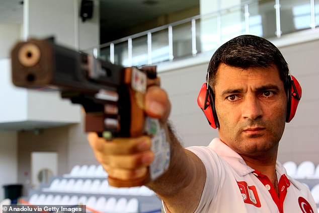 Dikec (seen in 2017) doesn't like to wear anything else but yellow earplugs while shooting