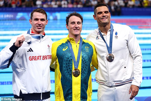 The Aussie touched the wall in a slick 21.25 seconds at the La Défense Arena ahead of Great Britain's Ben Proud and local hope Florent Manaudou (right)