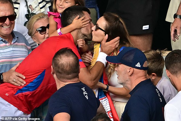 Djokovic pictured kissing wife Jelena after he completed a career Golden Slam on Sunday