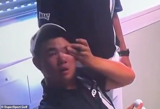 South Korean Kim pictured wiping away a tear from his left eye at Le Golf National on Sunday