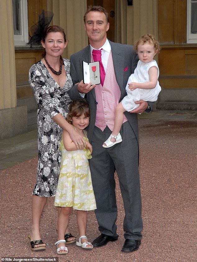 Graham Thorpe with his wife Amanda, children Kitty, then three, and Emma, then 20 months old, at his MBE investiture at Buckingham Palace in London on July 12, 2007