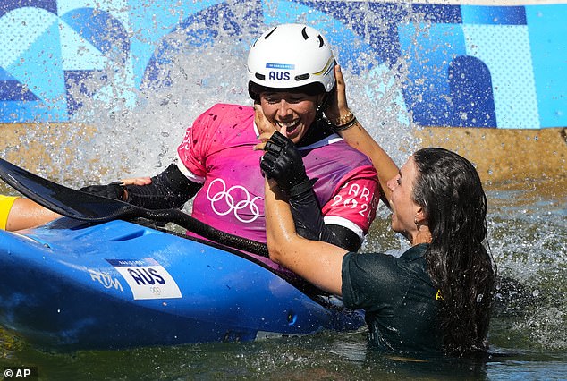 Jessica Fox jumps in the water to celebrate with her sister after the event