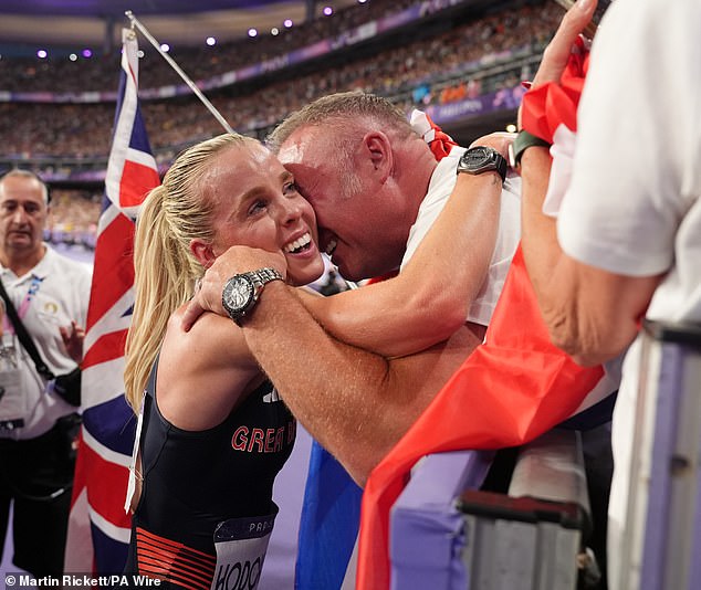 Her adoring father Dean Hodgkinson holds her in his arms after she won gold at the Olympics