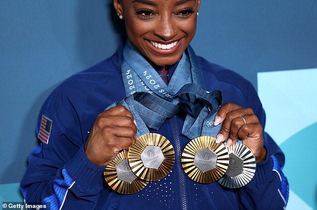Biles shows off the three gold medals and one silver she won at the 2024 Paris Olympics