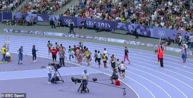 He seemed blissfully unaware of what was happening as the athletes ran straight past him