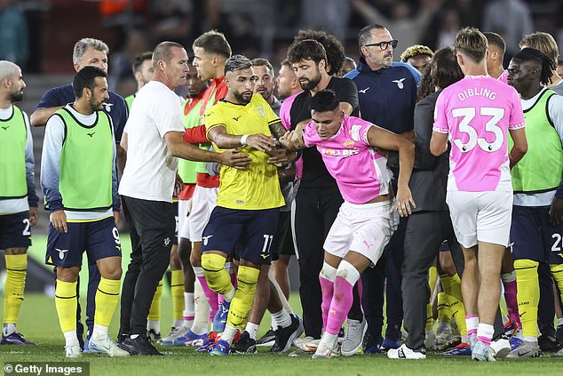 Saints manager Russell Martin (middle black top) tried to pull Alcaraz away from the chaos