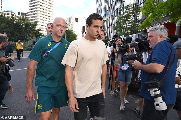 The 28-year-old is pictured with Australian hockey high performance boss Bernard Savage (left) on his way to tell the media he'd made a 'terrible mistake' after being released by police