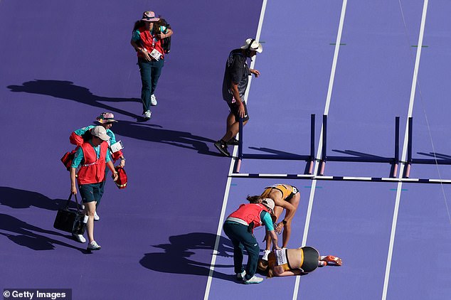Medics rushed to the scene to help the 26-year-old, who was also consoled by a fellow runner