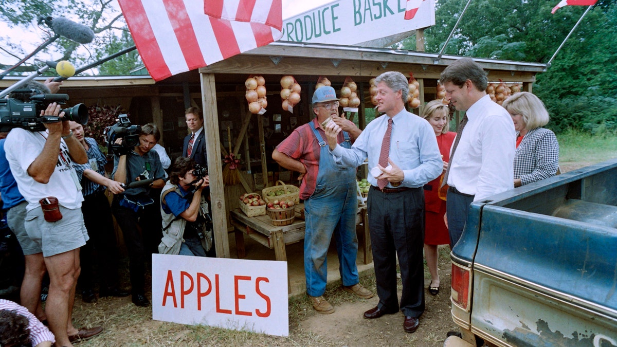 Democratic presidential candidate Bill Clinton with running mate Al Gore and their wives Tipper Gore and Hillary Clinton examining produce at a Georgia farm stand.