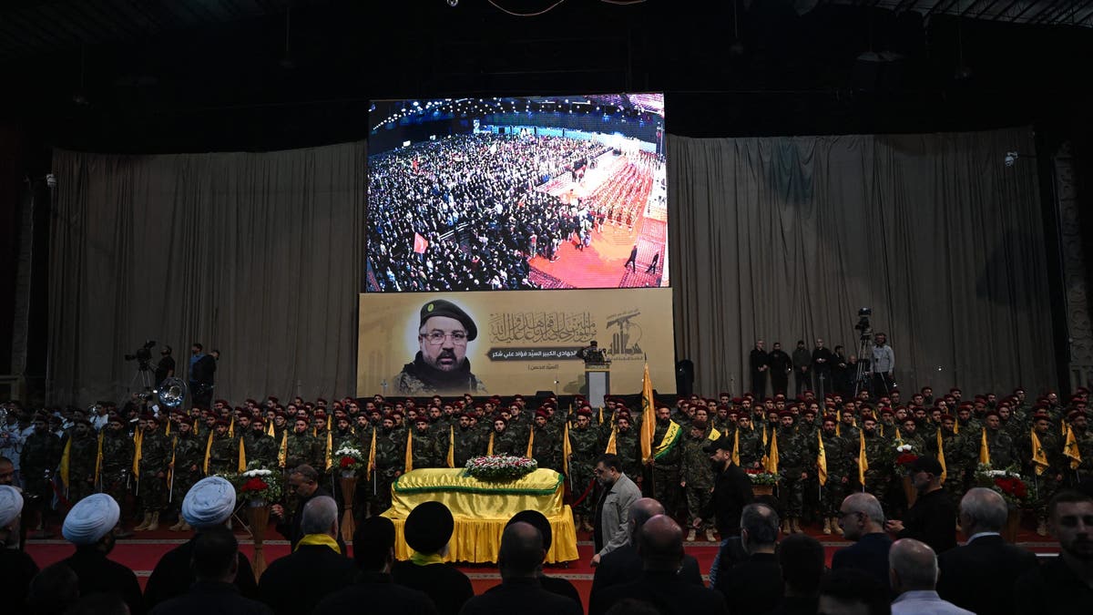 Hezbollah fighters and mourners attending the funeral of top commander Fuad Shukr in Beirut's southern suburbs on August 1, 2024. Hezbollah mourned Shukr, whose body was retrieved from the rubble of a July 30 Israeli strike killing five civilians, including three women and two children, and injuring many others, as fears of an escalating regional conflict grow.
