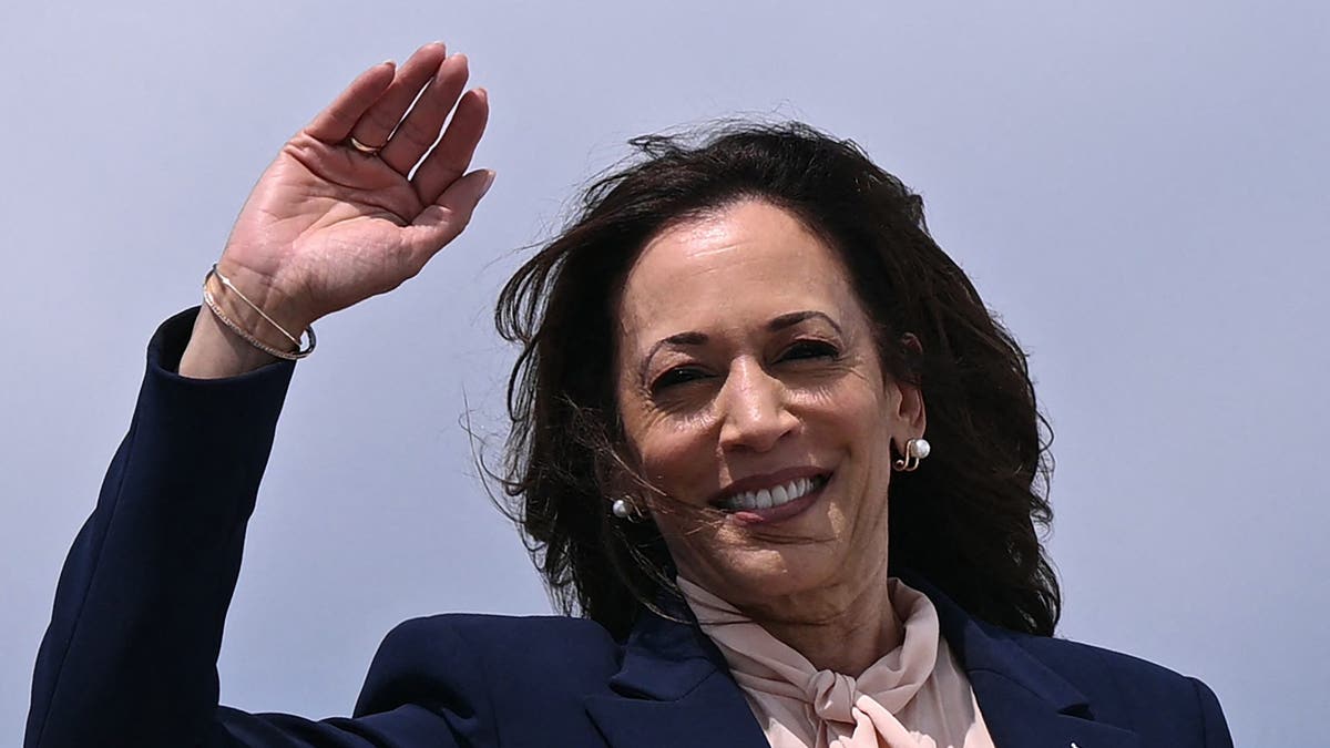 Vice President and 2024 Democratic presidential candidate Kamala Harris waves as she boards Air Force Two at Joint Base Andrews in Maryland on August 6, 2024, heading to a campaign event in Philadelphia after revealing Minnesota Governor Tim Walz as her vice presidential running mate. (Photo by Brendan SMIALOWSKI / POOL / AFP) (Photo by BRENDAN SMIALOWSKI/POOL/AFP via Getty Images)