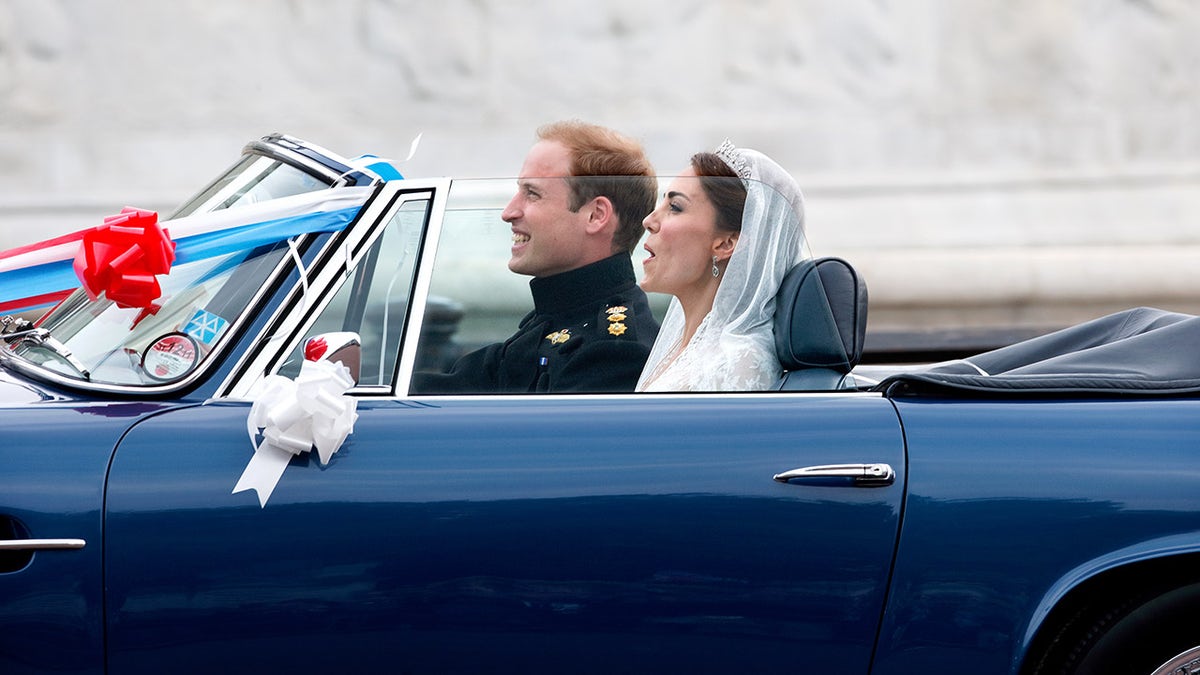 Prince William and Kate Middleton departing in a blue car after their wedding.