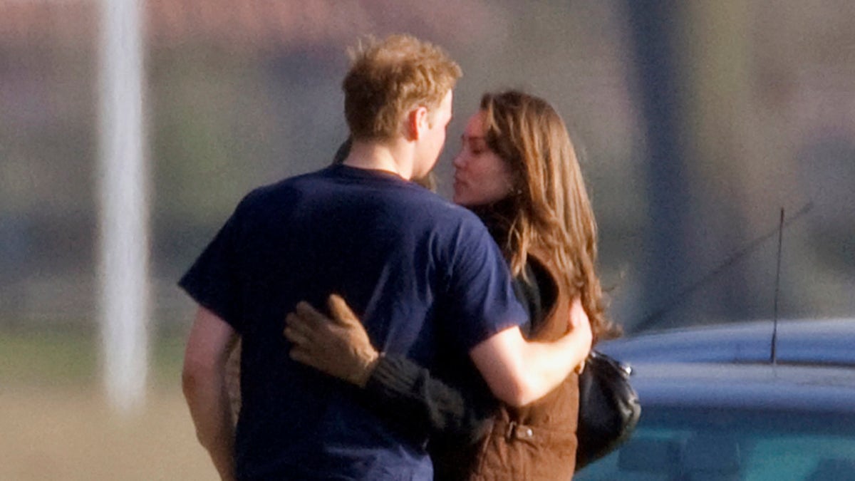 Prince William and Kate Middleton sharing a kiss.