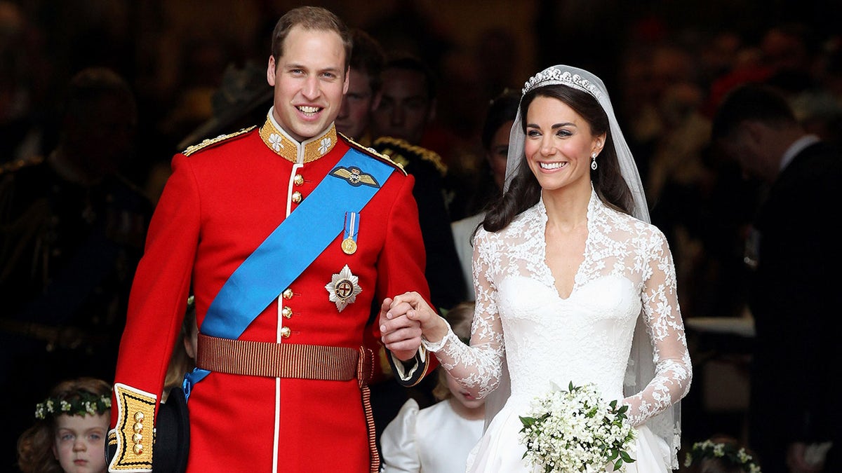 Prince William and Kate Middleton holding hands on their wedding day.