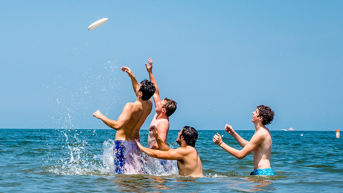 boys playing catch with frisbee