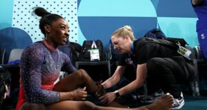 Simone Biles reveals the damage to her calf as she wears protective BOOT following painful end to Paris Olympics