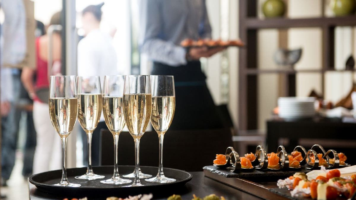 Wedding reception with champagne and canapés on table.