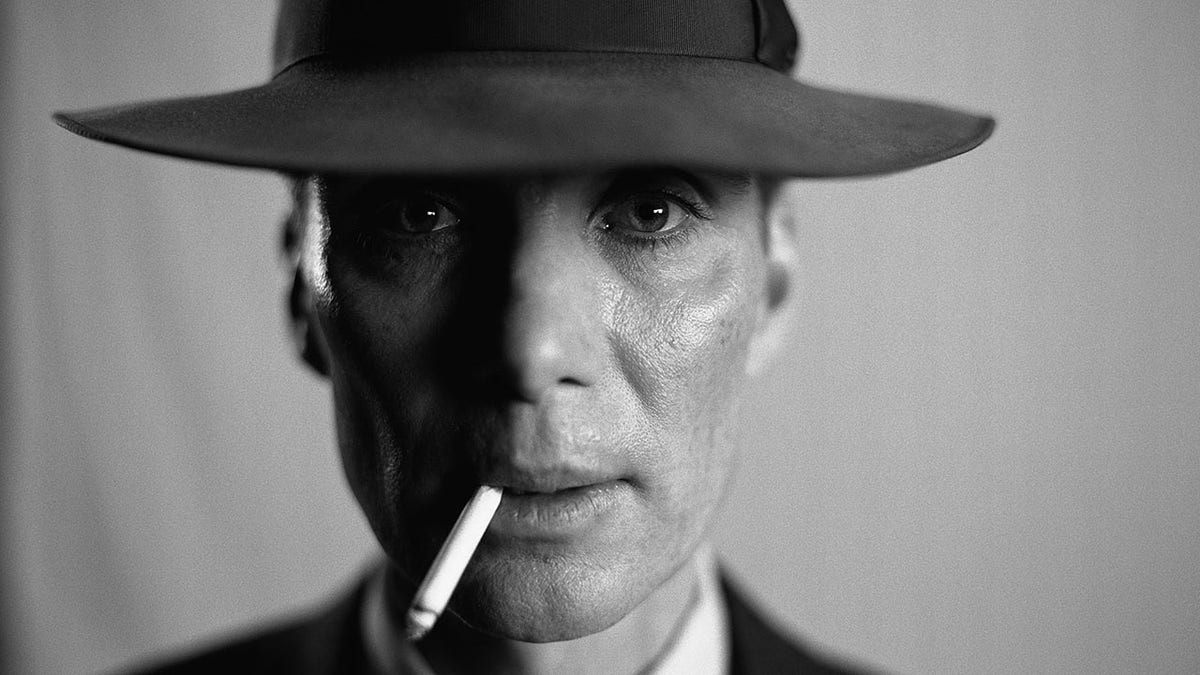 Cillian Murphy as J. Robert Oppenheimer gazing directly into the camera with a cigarette in mouth